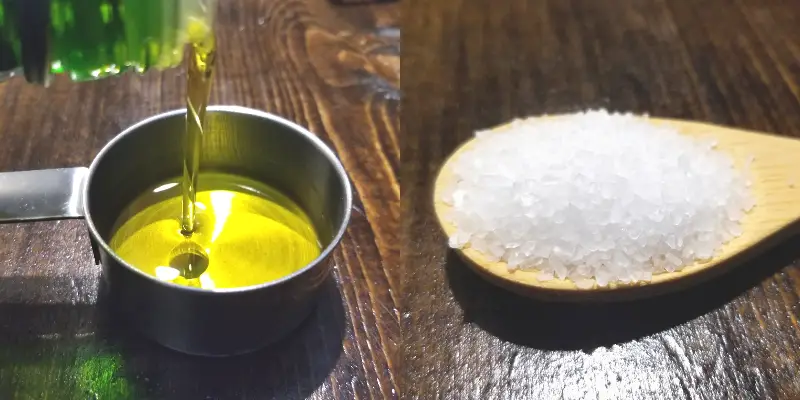 Olive oil pouring into a measuring cup and salt on a spoon