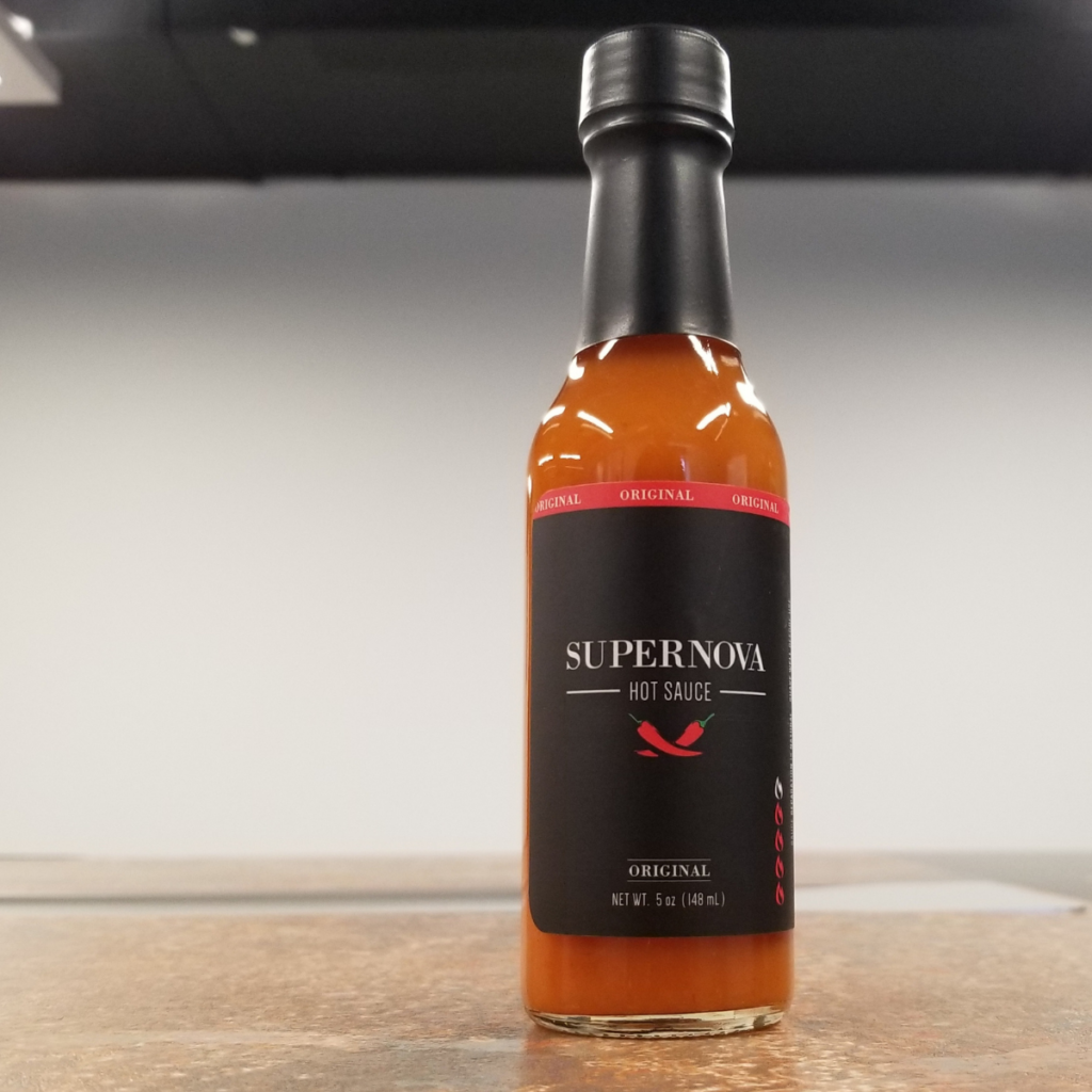 The front of a bottle of Supernova Original Hot Sauce