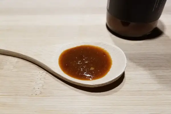 Mojo Peppa Sauces Chocolate Habanero with Black Garlic on a wooden spoon to show texture