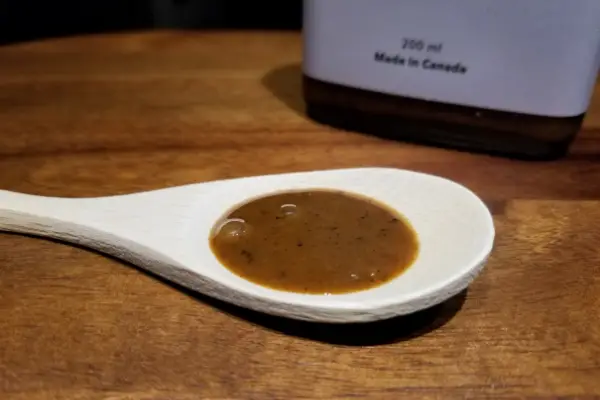 The appearance of Coffee Hot Sauce by Saus is thin and a brown colour