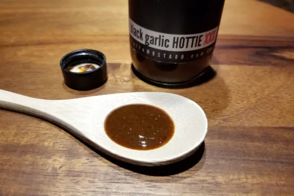 Black Garlic Hottie hot sauce on a spoon