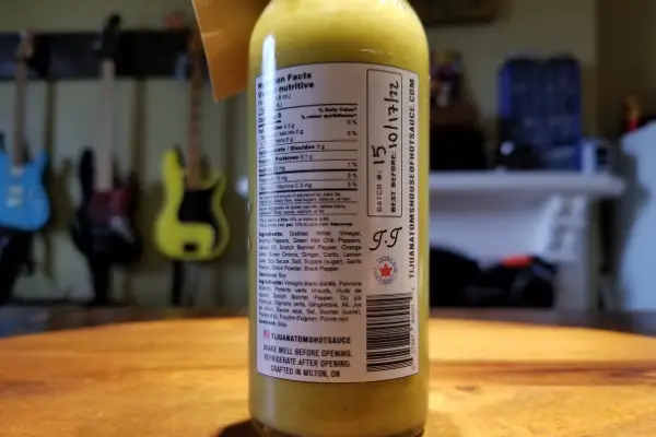 The nutritional label and the batch info on a bottle of Tijuana Tom's Asian Kick Hot Sauce