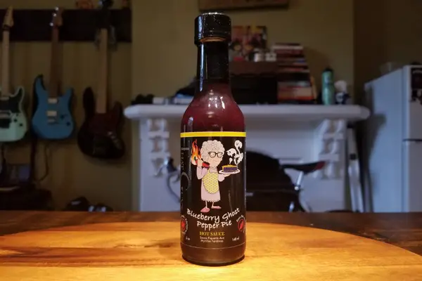 a bottle of blueberry ghost pepper pie hot sauce