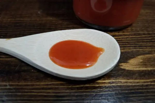 Spicy Garlic Pepper Sauce on a spoon to show texture