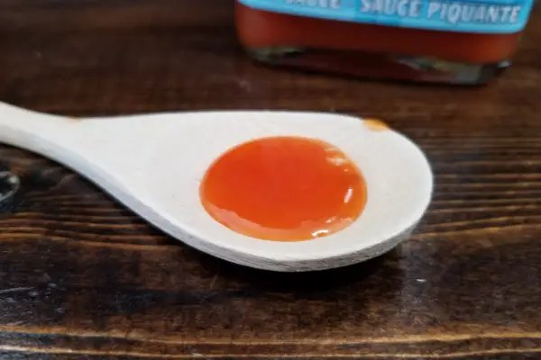 Flavour Factory's Hot Pursuit hot sauce on a spoon to show texture