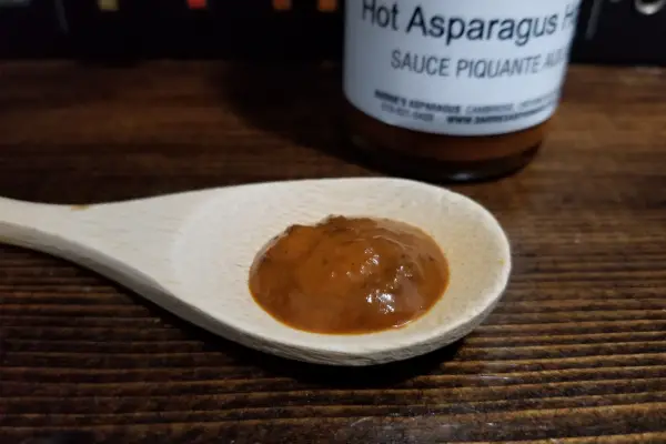Barrie's Hot Asparagus Hot Sauce on a spoon to show texture