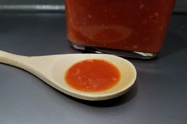 Scorpion Sriracha sauce by The Hot Sauce Co. on a spoon to show texture