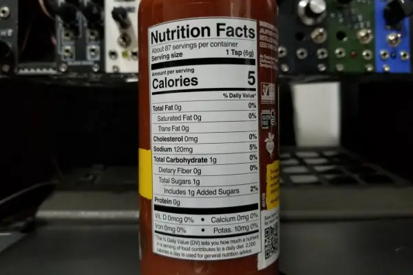 The nutritional info on a bottle of Sriracha sauce by Sky Valley