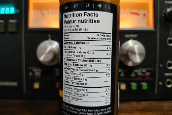 The nutritional info on a bottle of Triple Heat Sweet Potato Hot Sauce by MH Fine Foods.