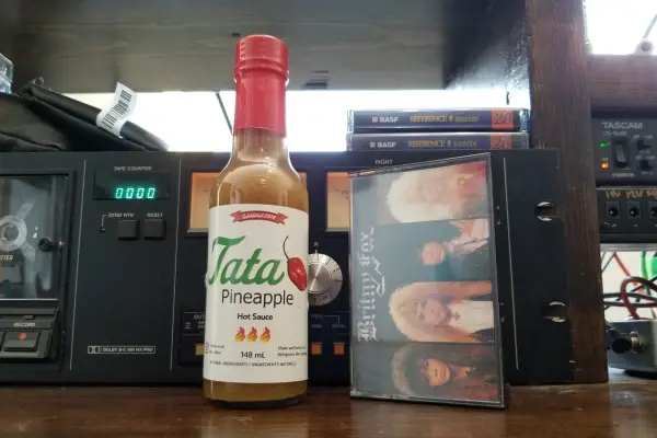A bottle of Pineapple Extra Hot Sauce by Tata Hot Sauce