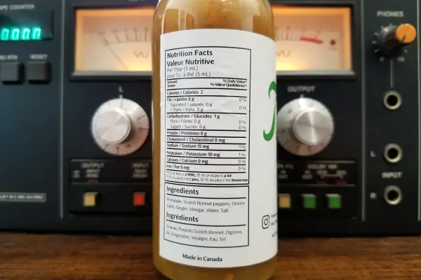 The nutritional label on a bottle of Tata's Pineapple Extra Hot Sauce