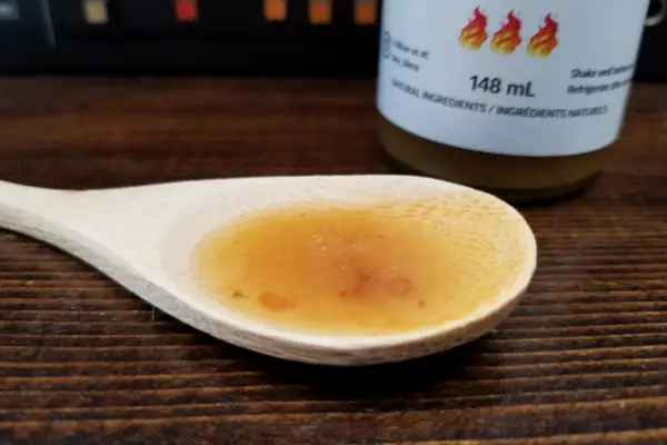 Tata's Extra Hot Pineapple sauce on a spoon to show texture