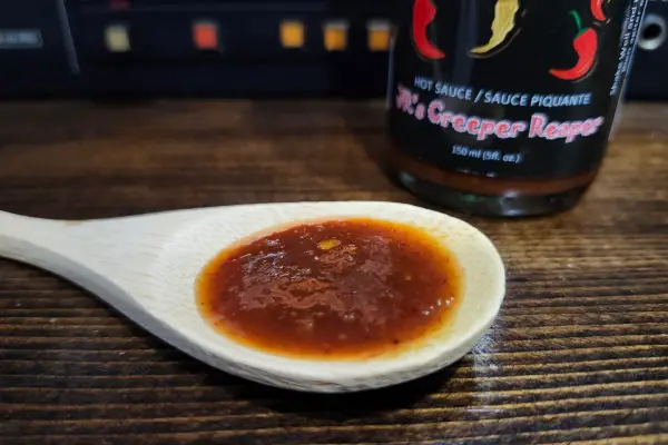 Creeper Reaper Hot Sauce on a spoon to show texture.