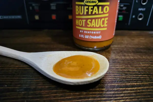 Hot Ones Buffalo Sauce on a spoon to show texture