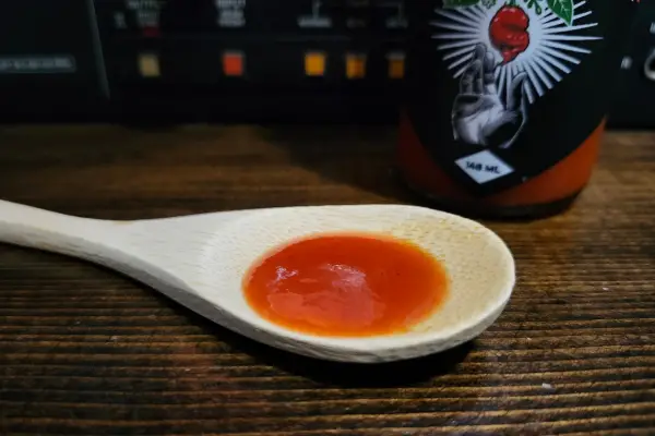 Forbidden Fruit hot sauce on a spoon to show texture