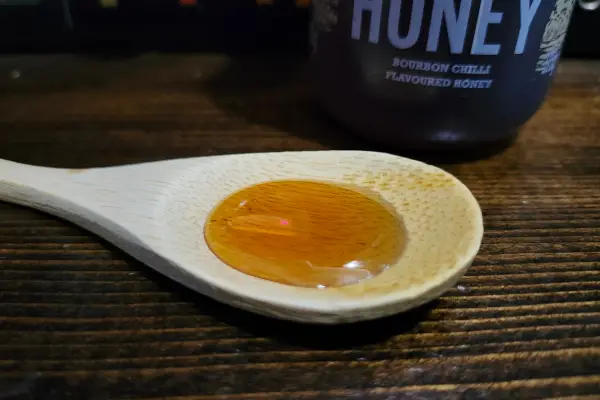 Bourbon Hot Honey on a spoon to show texture