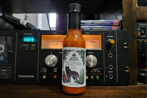 A bottle of Red Habanero and Black Coffee hot sauce by Queen Majesty