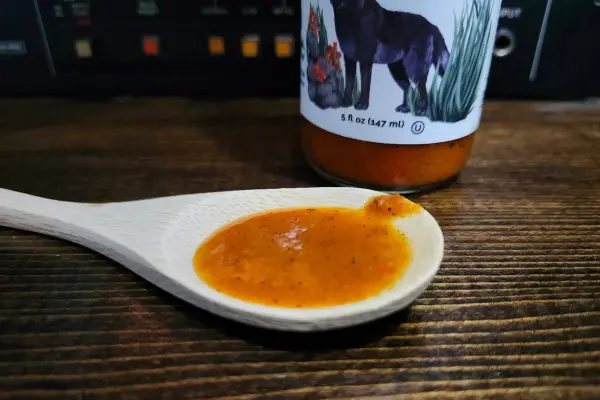 Red Habanero and Black Coffee hot sauce on a spoon to show texture