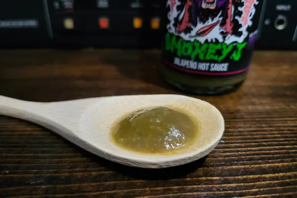 Smokey J hot sauce on a spoon to show texture.
