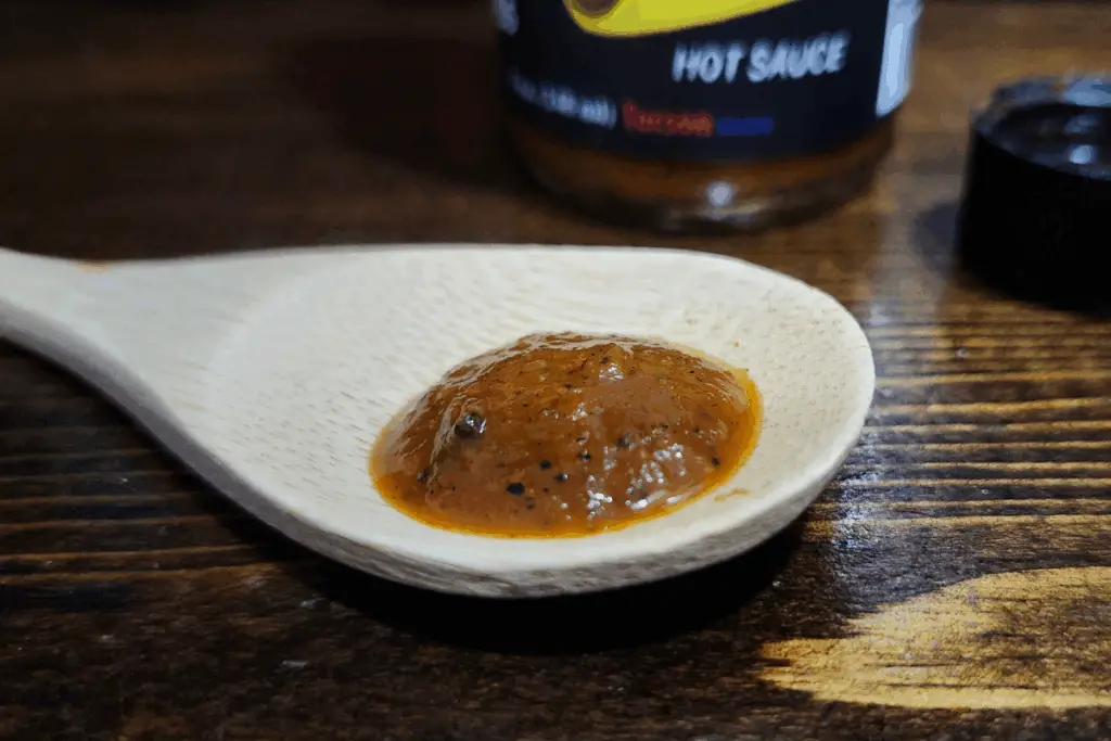 Hotter Ghost of Saffron hot sauce on a spoon to show texture